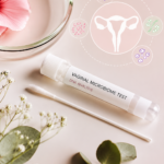 Vaginal microbiome test kit with vaginal swab and DNA analysis tube displayed beside a feminine reproductive health illustration on a soft pastel background.